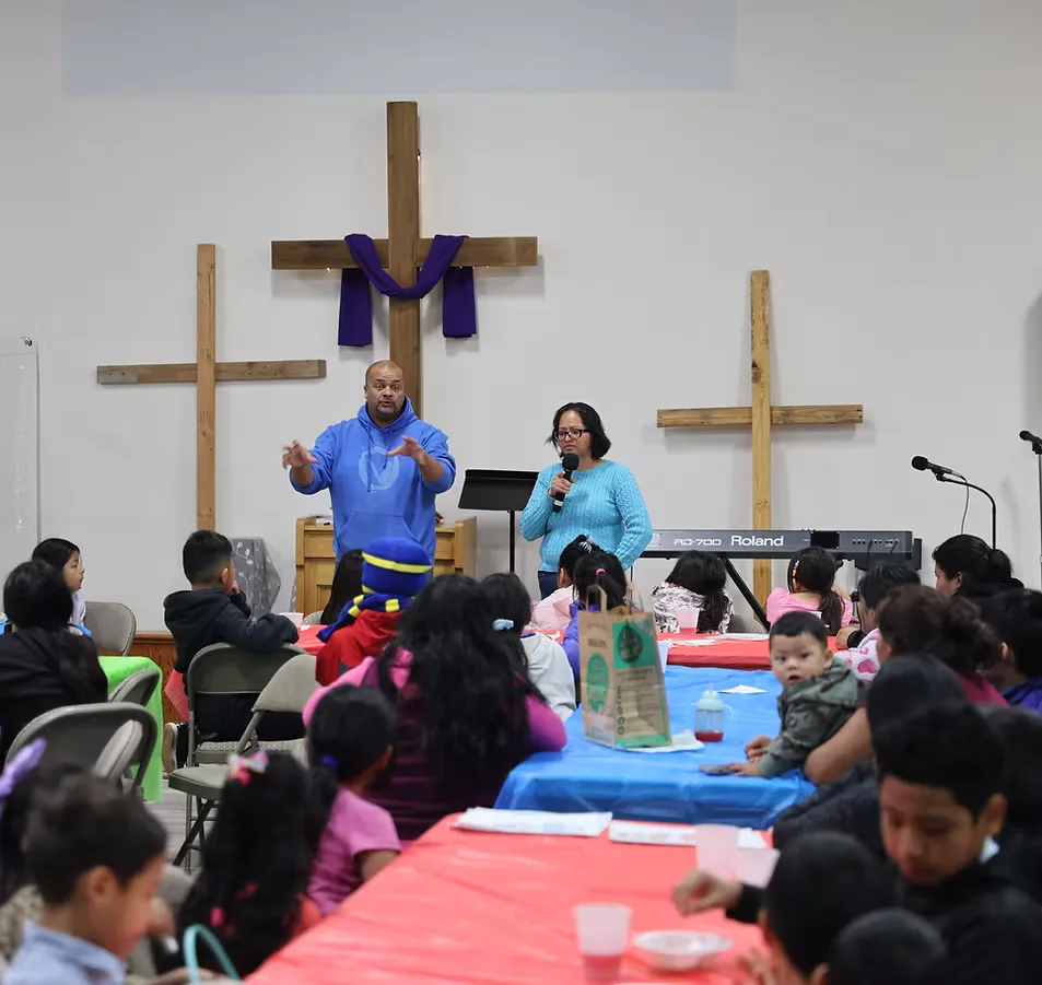 A gathering at Cactus Nazarene Ministry Center with two wooden crosses at the front